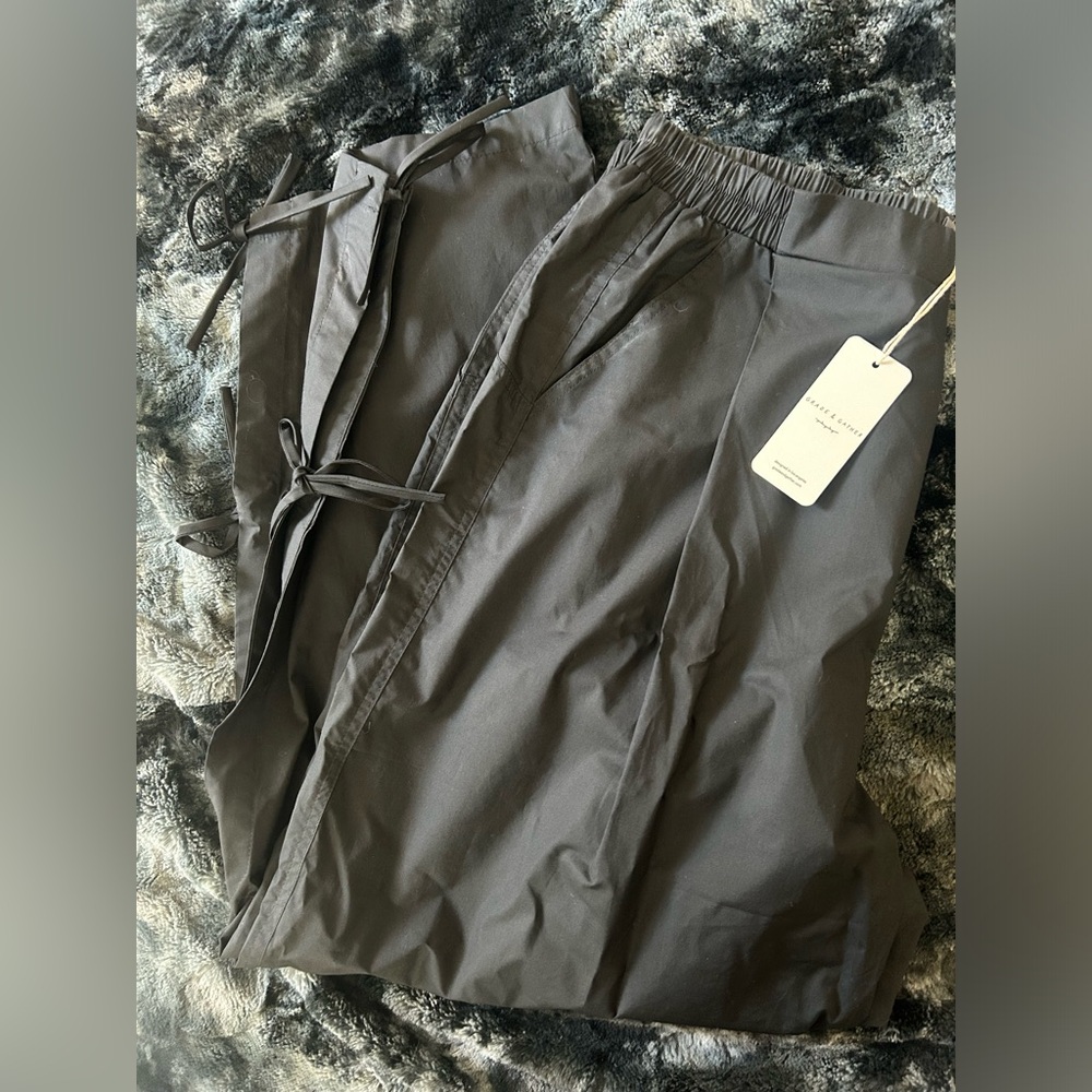 Black tie-leg canvas pants.